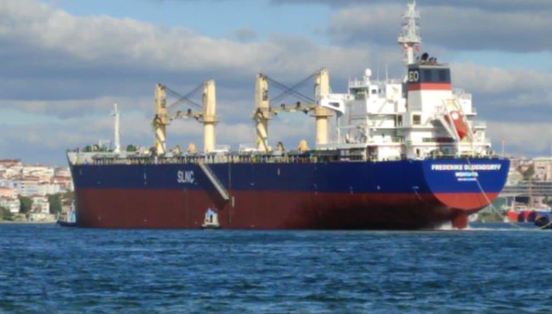 large red and blue ship in the ocean